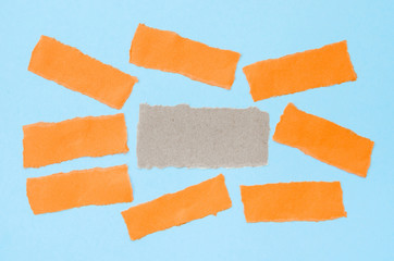 Piece of sheet blank colorful paper on a blue background.