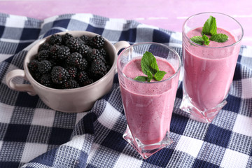Fototapeta na wymiar Delicious berry smoothie with blackberries on table close up