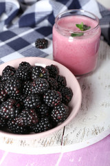 Delicious berry smoothie with blackberries on table close up