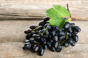 Fresh ripe grapes on old wooden table