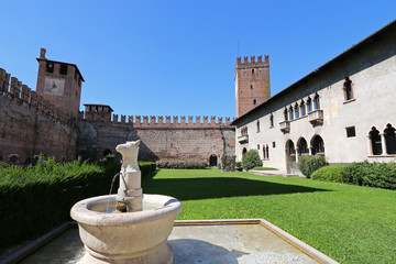 An ancient A bull-headed fountain in the courtyard at Castelvecchio Museum (Museo Civico di...