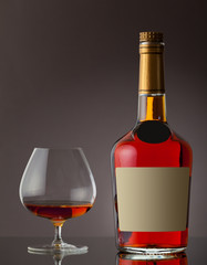 Bottle of cognac and glass