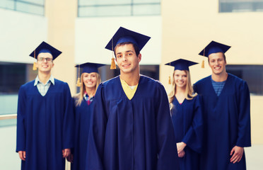 group of smiling students in mortarboards