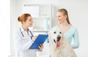 happy doctor with retriever dog at vet clinic