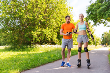 happy couple with roller skates riding outdoors