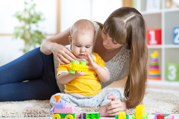baby boy playing toys together mother