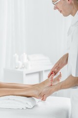 Obraz na płótnie Canvas Masseur doing foot massage