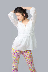 Beautiful girl posing in studio isolated on gray background