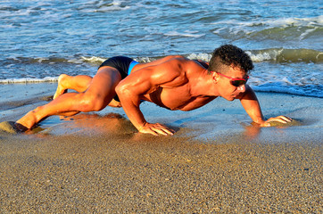 Strong bodybuilder with six pack.Fitness trainer with perfect abs, shoulders,biceps, triceps,chest,...