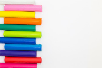 Fototapeta premium Rainbow colors clay for child's play on white background