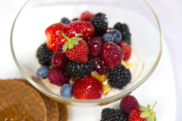 Tasty breakfast with yogurt, waffles and berries