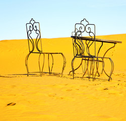 table and seat in desert  sahara morocco africa yellow sand