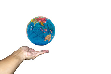 Hand holding globe model on white background.