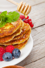 Pancakes with raspberry, blueberry, mint and honey syrup