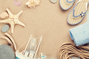 Fototapeta na wymiar Travel and vacation items on sea sand