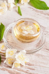 kettle and a cup of green tea with jasmine, close-up