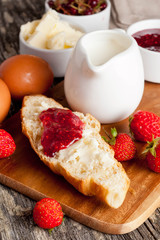 Breakfast with croissant, jam, fresh berries and butter