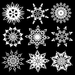 Set of white snowflakes on a black background