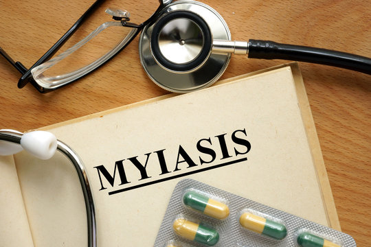 Word Myiasis  on a book and pills.