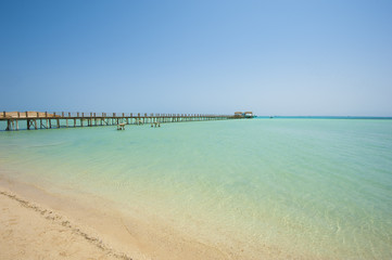Fototapeta na wymiar Wooden jetty on a tropical island beach