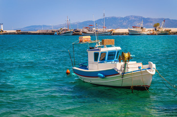 Naklejka na ściany i meble Blue-white boat floating on clear water, Greece