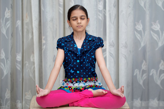 young indian girl or kid doing yoga and pranayam at such an early age for a healthy and peaceful lifestyle