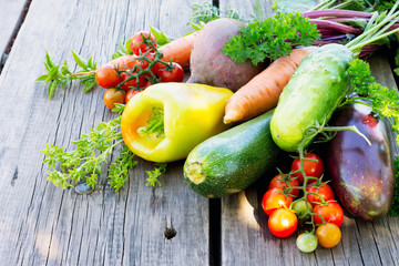 Vegetables on a wooden background: sweet pepper, tomato, eggplant