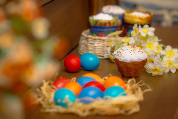 Easter eggs in nest on wooden background