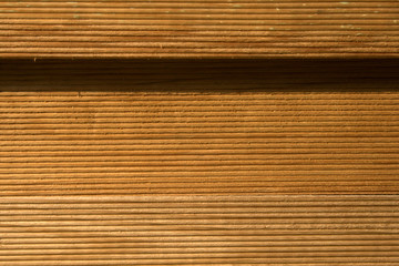 Brown wooden fence panels with ridges close up, texture material