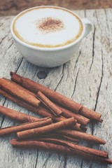 Cappuccino coffee with cinnamon sticks