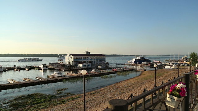 Ships float on the River Volga near the pier and boathouse
