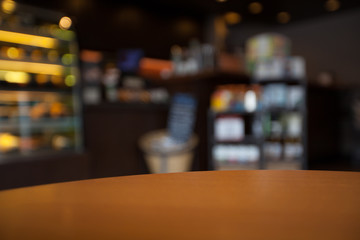 Empty round table top at coffee shop blurred background with bok