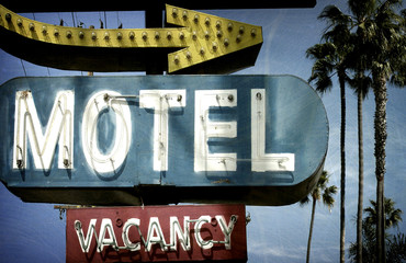 neon motel sign with palm trees