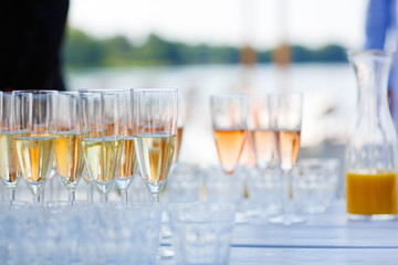 Glasses with champagne and wine on summer wedding