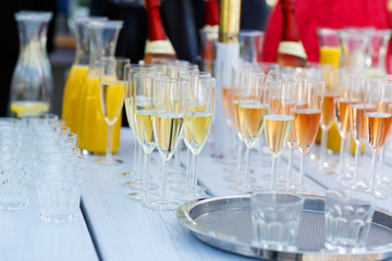 Glasses with champagne and wine on summer wedding