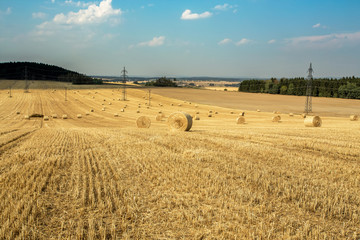 Fototapeta premium Beautiful landscape with straw bales in harvested fields