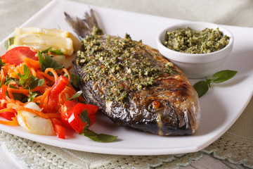 The gilt-head bream fish with pesto and salad macro. Horizontal
