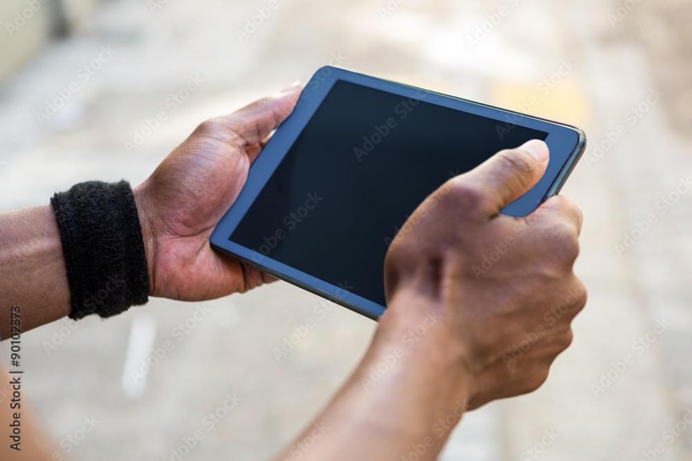 Poster Athletic man using tablet computer