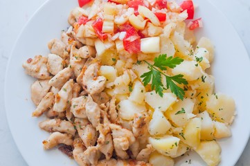 Chicken curry nuggets with potato and vegetables on plate