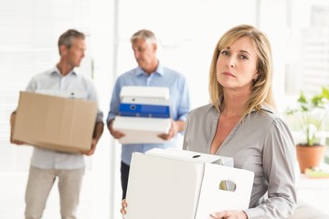 Disappointed casual businesswoman with carton