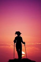 Nordic walking silhouette at sunset