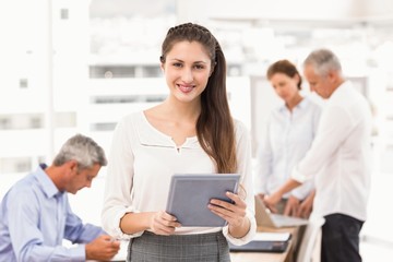 Fototapeta premium Smiling businesswoman with tablet in a meeting 