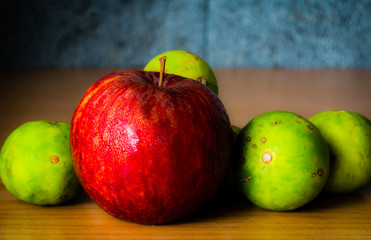 Red Apple, Lime and Coffee bean on a wood with Selective focus, Vintage tone.