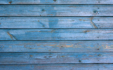 light blue wooden house wall with peeling paint, texture