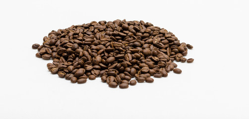 Roasted coffee beans pile from top on white background