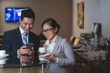 Showing funny picture to colleague