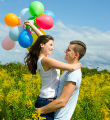 Happiness: Young couple in love with colorful balloons :)
