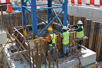 Group of construction workers fabricating pile cap formwork