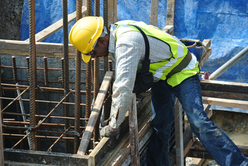 A construction workers fabricating pile cap formwork