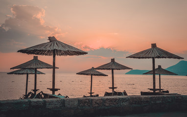 Fototapeta na wymiar Umbrellas on the beach. Retro style filter
